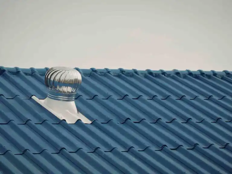 Roof vent installed on a corrugated blue metal roof