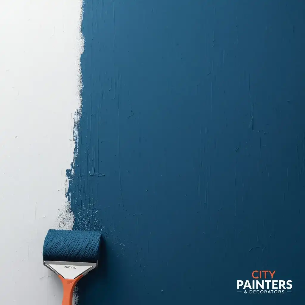 Small paint roller applying dark blue paint onto a plain white wall