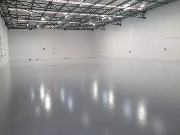 Spacious empty warehouse interior with glossy painted epoxy floor