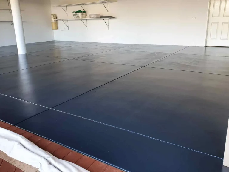 Dark painted epoxy floor surface inside an industrial facility or garage