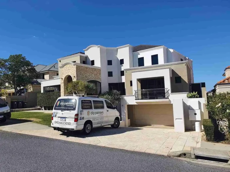 Multi-story modern white house exterior with a white van parked outside