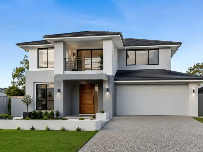 Front view of a modern two-story white and grey house with garage and lawn