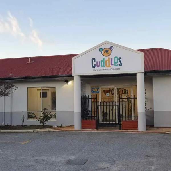 Single-story commercial building exterior with a service van parked outside