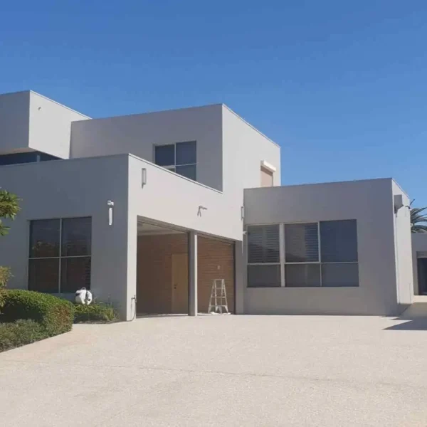 Exterior view of a modern grey residential house with wide driveway