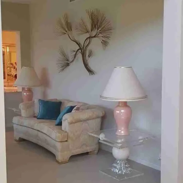 Bright indoor hallway leading to a living room with a sofa and lamp